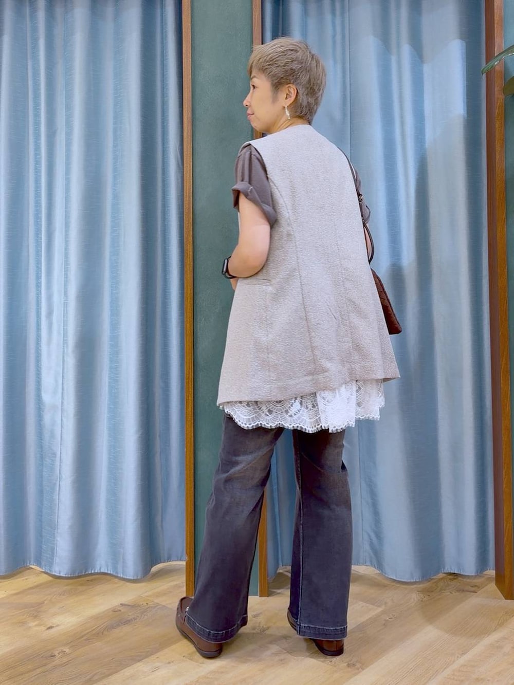 ブラウン系のショルダーバッグ、ブラウン系のローファー、グレー系のTシャツ/カットソーを着用したレディースの夏コーディネートの6枚目の写真