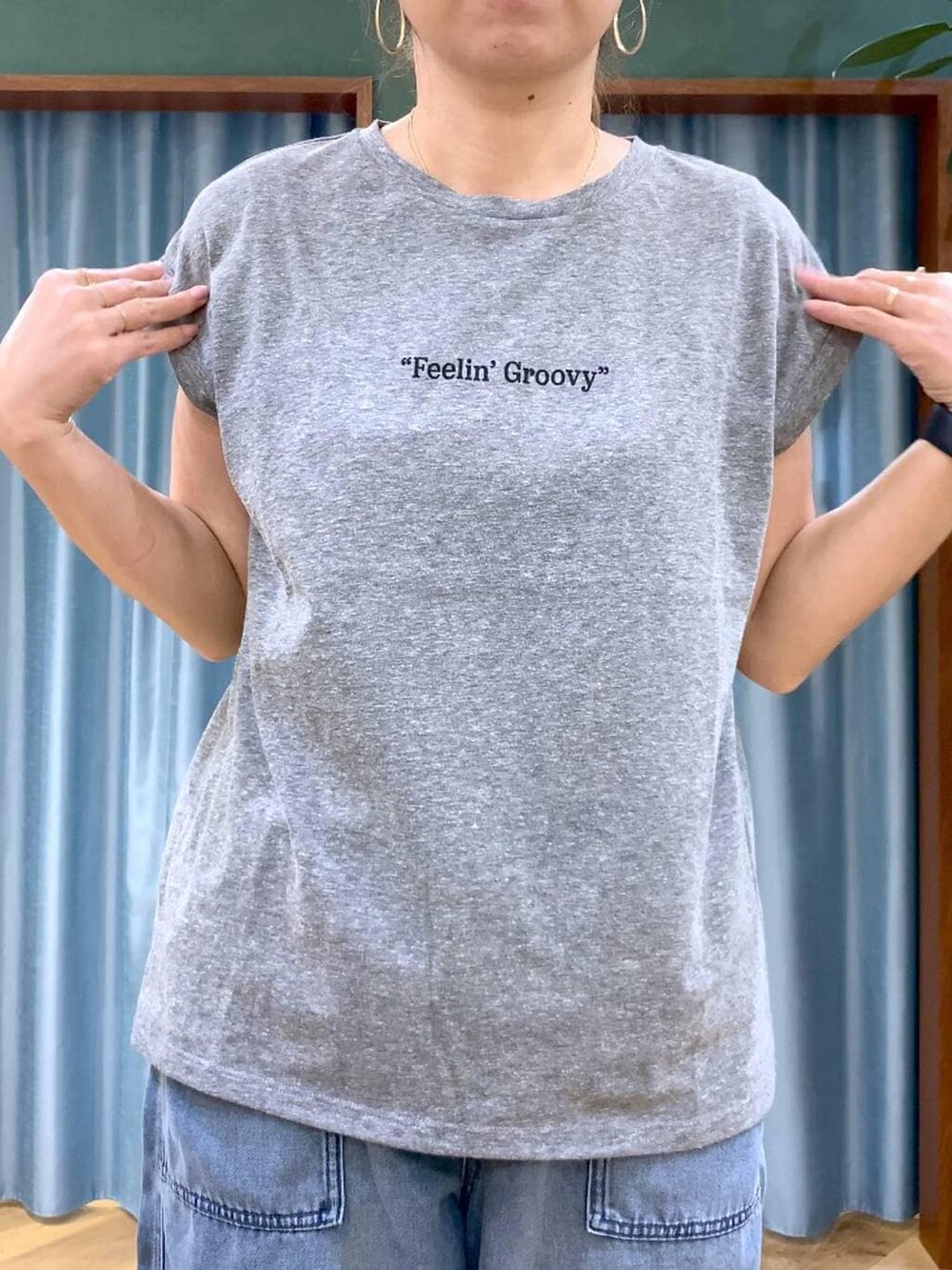 ブルー系のデニムパンツ、ベージュ系のブルゾン、グレー系のTシャツ/カットソーを着用したレディースの春コーディネートの3枚目の写真