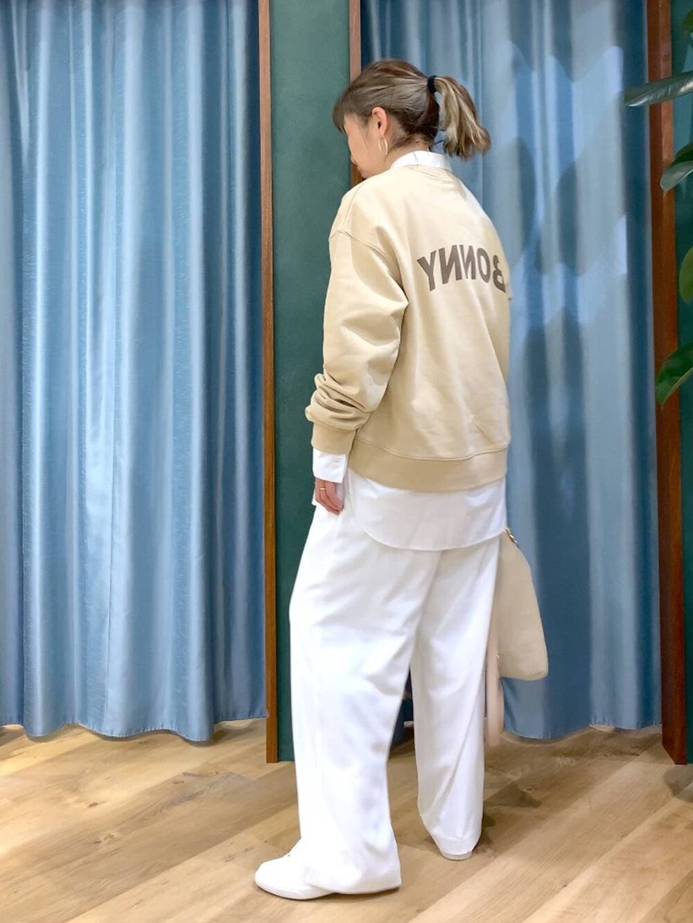 ホワイト系のスラックス、ホワイト系のシャツ/ブラウス、ベージュ系のスウェットを着用したレディースの冬コーディネートの6枚目の写真