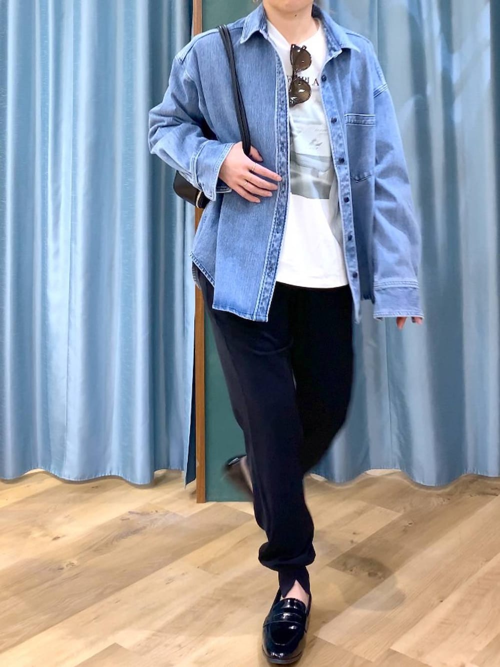 ブルー系のシャツ/ブラウス、ホワイト系のTシャツ/カットソー、ブラック系のハンドバッグを着用したレディースの春コーディネートの9枚目の写真