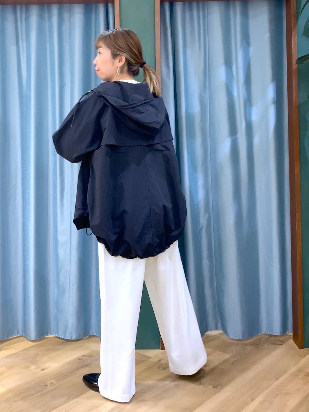 ホワイト系のスラックス、ベージュ系のTシャツ/カットソー、ブラック系のローファーを着用したレディースの春コーディネートの2枚目の写真