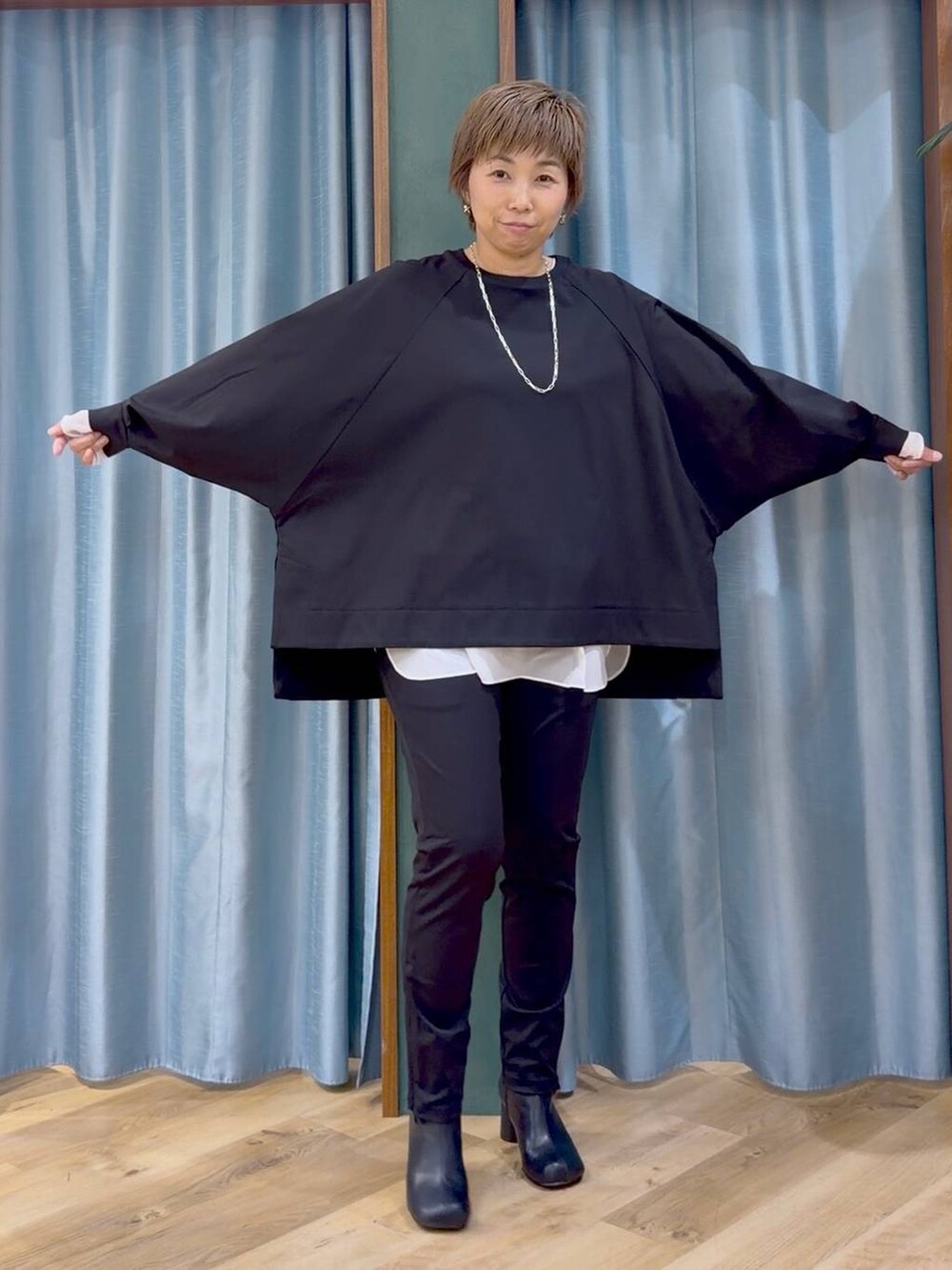 ブラック系のその他パンツ、ブラック系のブーツ、ホワイト系のTシャツ/カットソーを着用したレディースの秋コーディネートの8枚目の写真