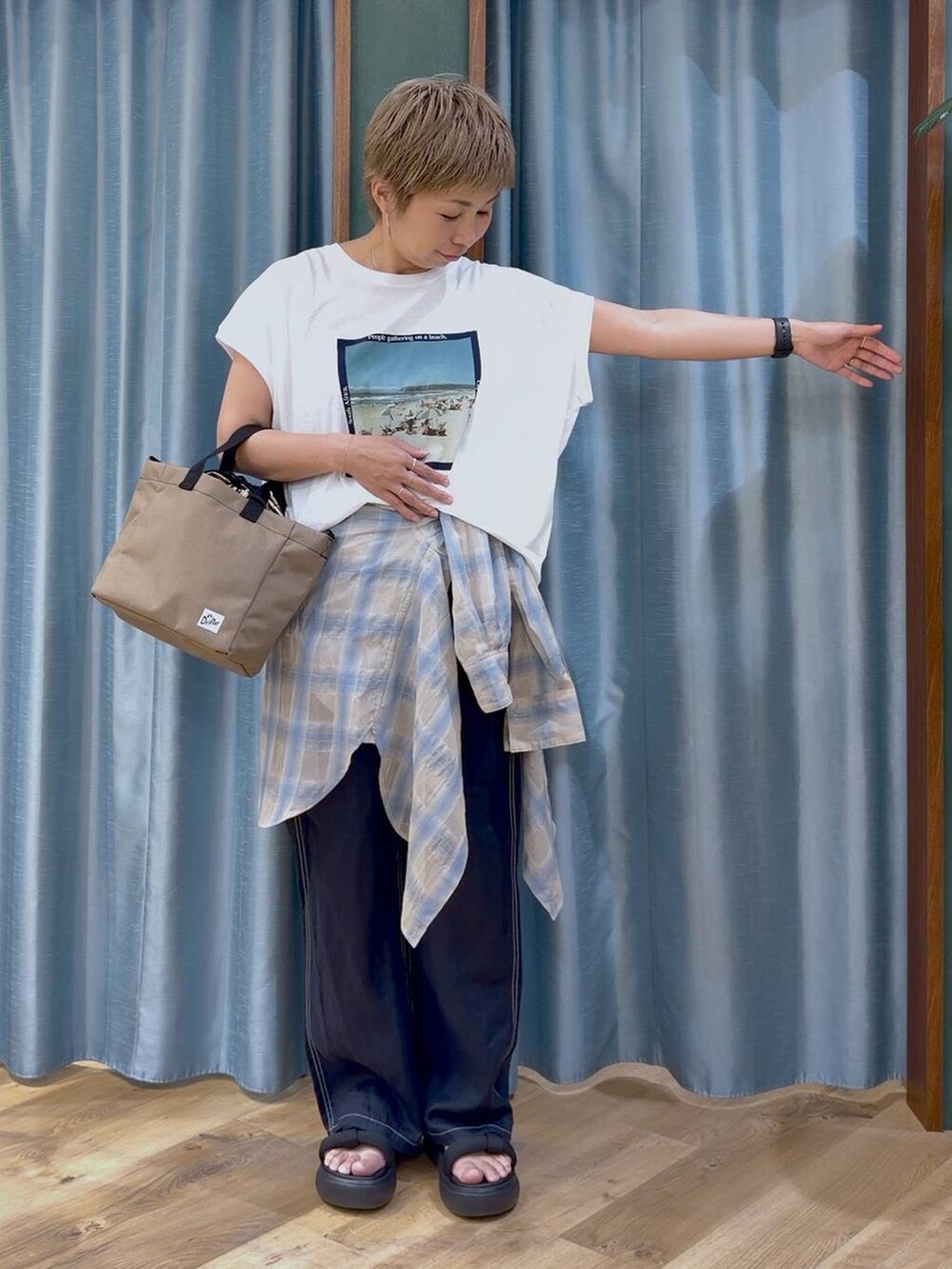 ホワイト系のTシャツ/カットソー、ブルー系のその他パンツ、ベージュ系のショルダーバッグを着用したレディースの夏コーディネートの6枚目の写真