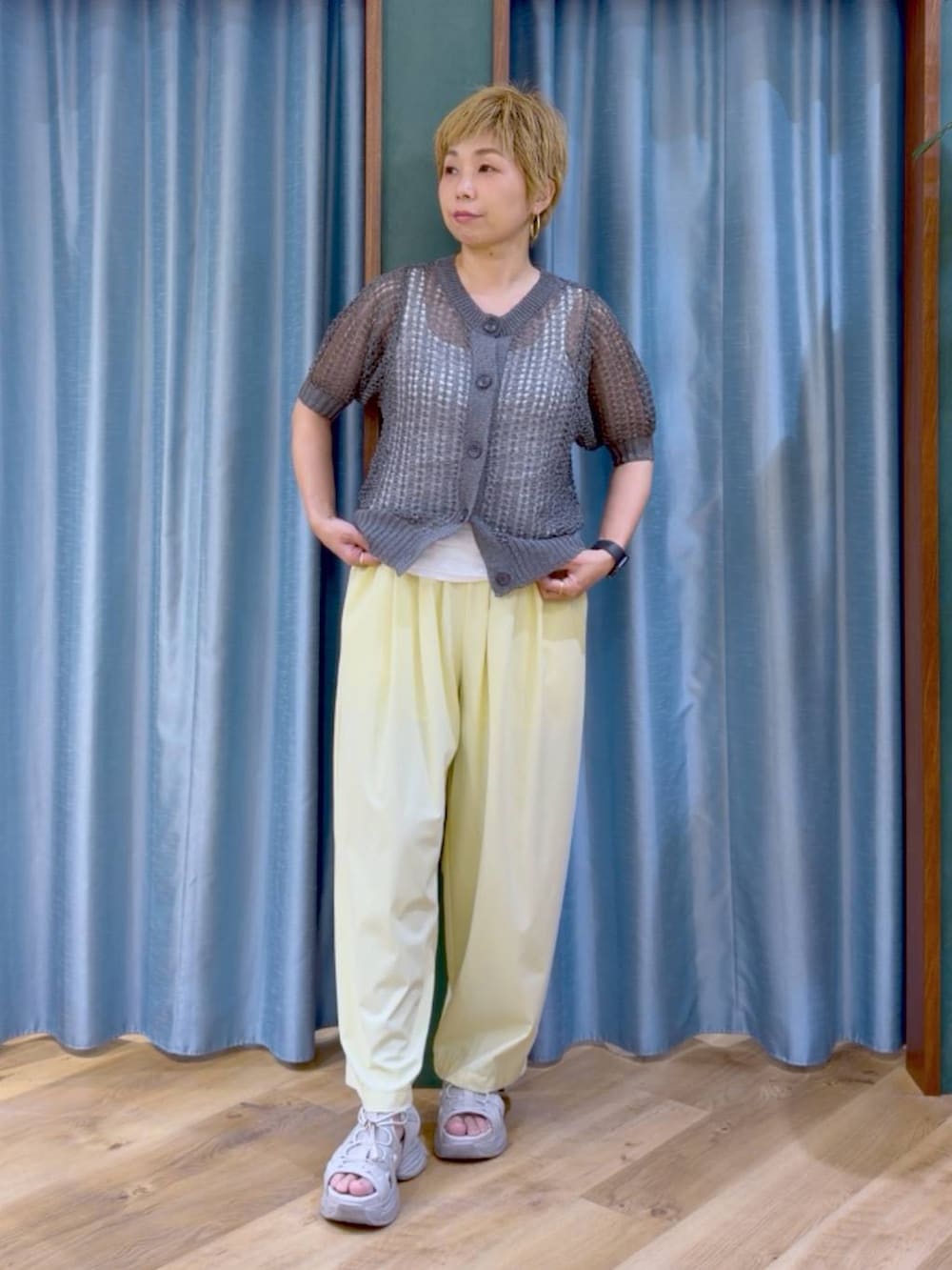ホワイト系のタンクトップ、イエロー系のその他パンツ、グレー系のサンダルを着用したレディースの夏コーディネートの2枚目の写真