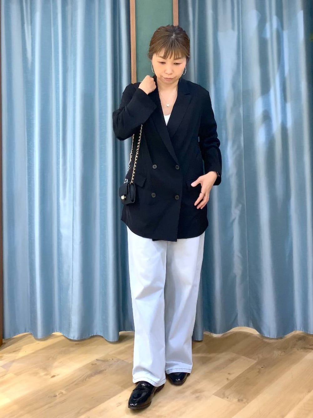 ホワイト系のその他トップス、ブルー系のデニムパンツ、ブラック系のテーラードジャケットを着用したレディースの冬コーディネートの5枚目の写真