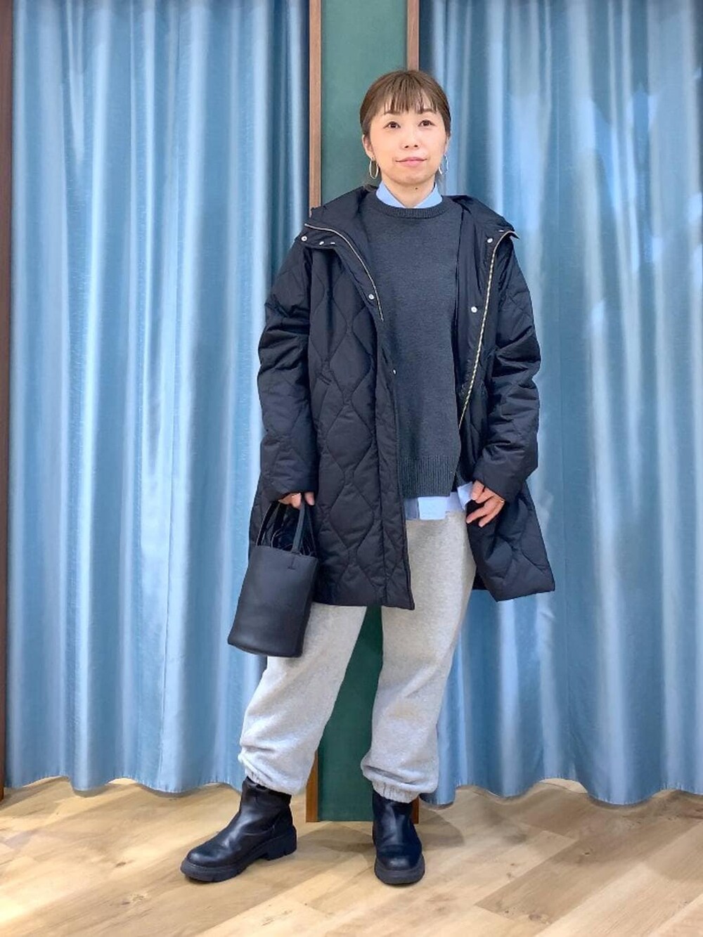 ブルー系のシャツ/ブラウス、ブラック系のブルゾン、グレー系のスウェットパンツを着用したレディースの冬コーディネートの2枚目の写真