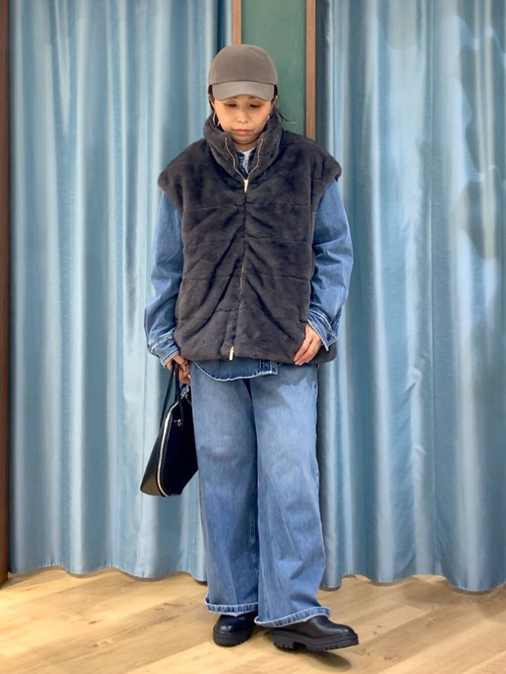 ブラック系のブーツ、ブルー系のシャツ/ブラウス、ブルー系のデニムパンツを着用したレディースの秋コーディネートの3枚目の写真