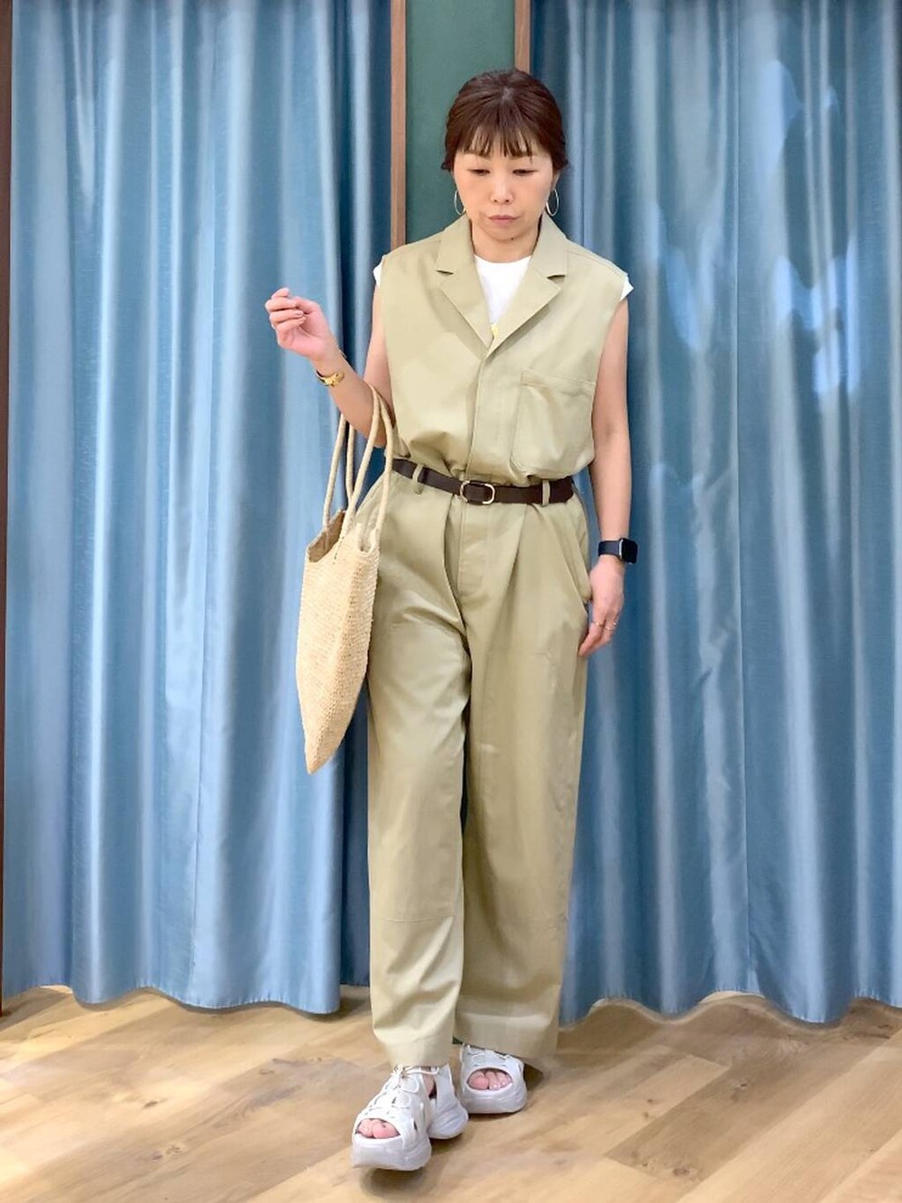 ホワイト系のTシャツ/カットソー、ベージュ系のつなぎ/オールインワン、グレー系のサンダルを着用したレディースの春コーディネートの2枚目の写真