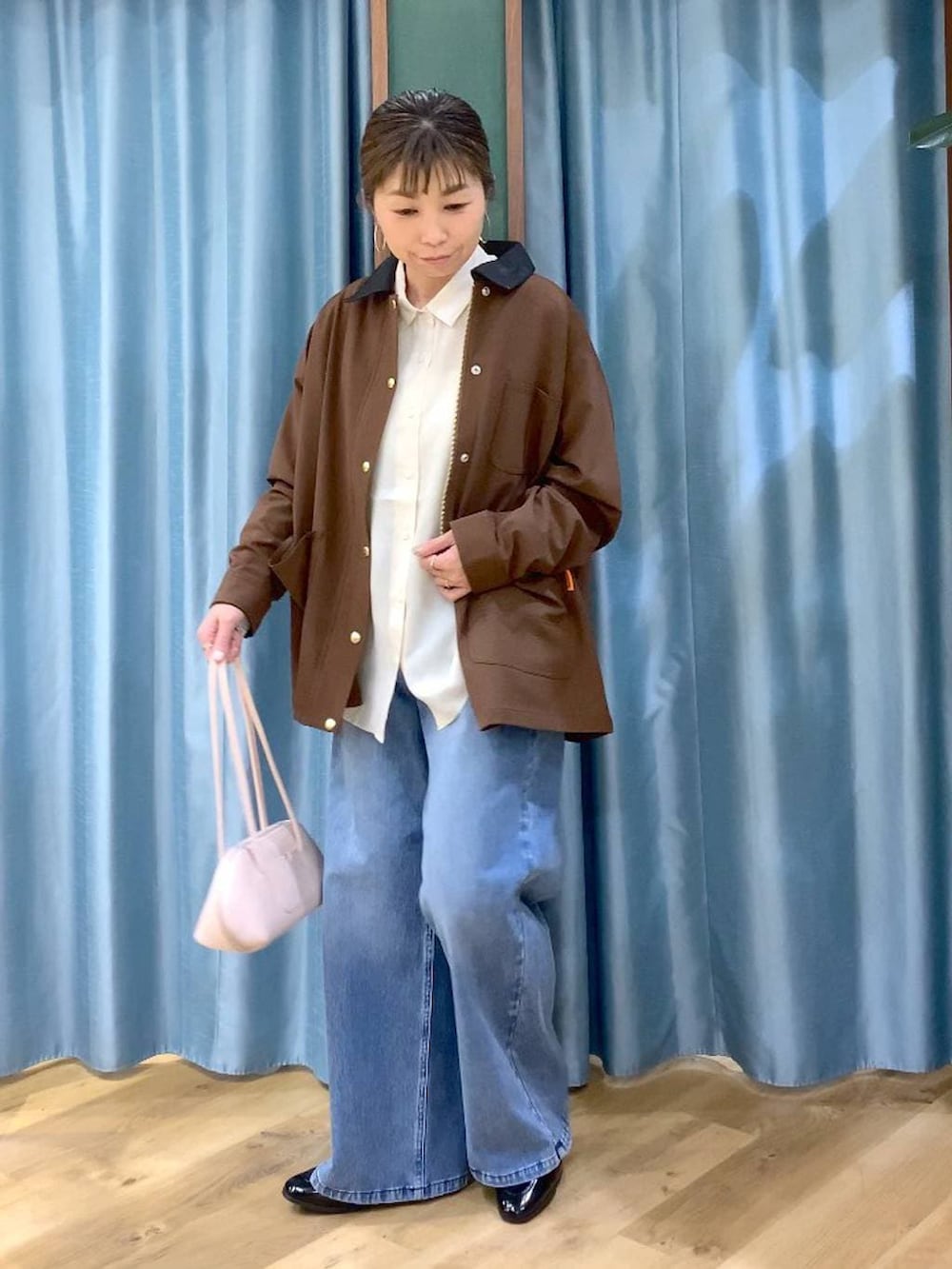 ブルー系のデニムパンツ、ブラウン系のカバーオール、ブラック系のローファーを着用したレディースの冬コーディネートの5枚目の写真