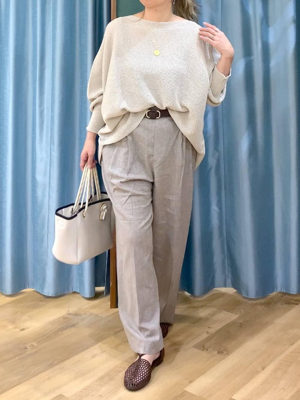 ベージュ系のニット/セーター、ホワイト系のトートバッグ、ベージュ系のその他パンツを着用したレディースの春コーディネートの6枚目の写真