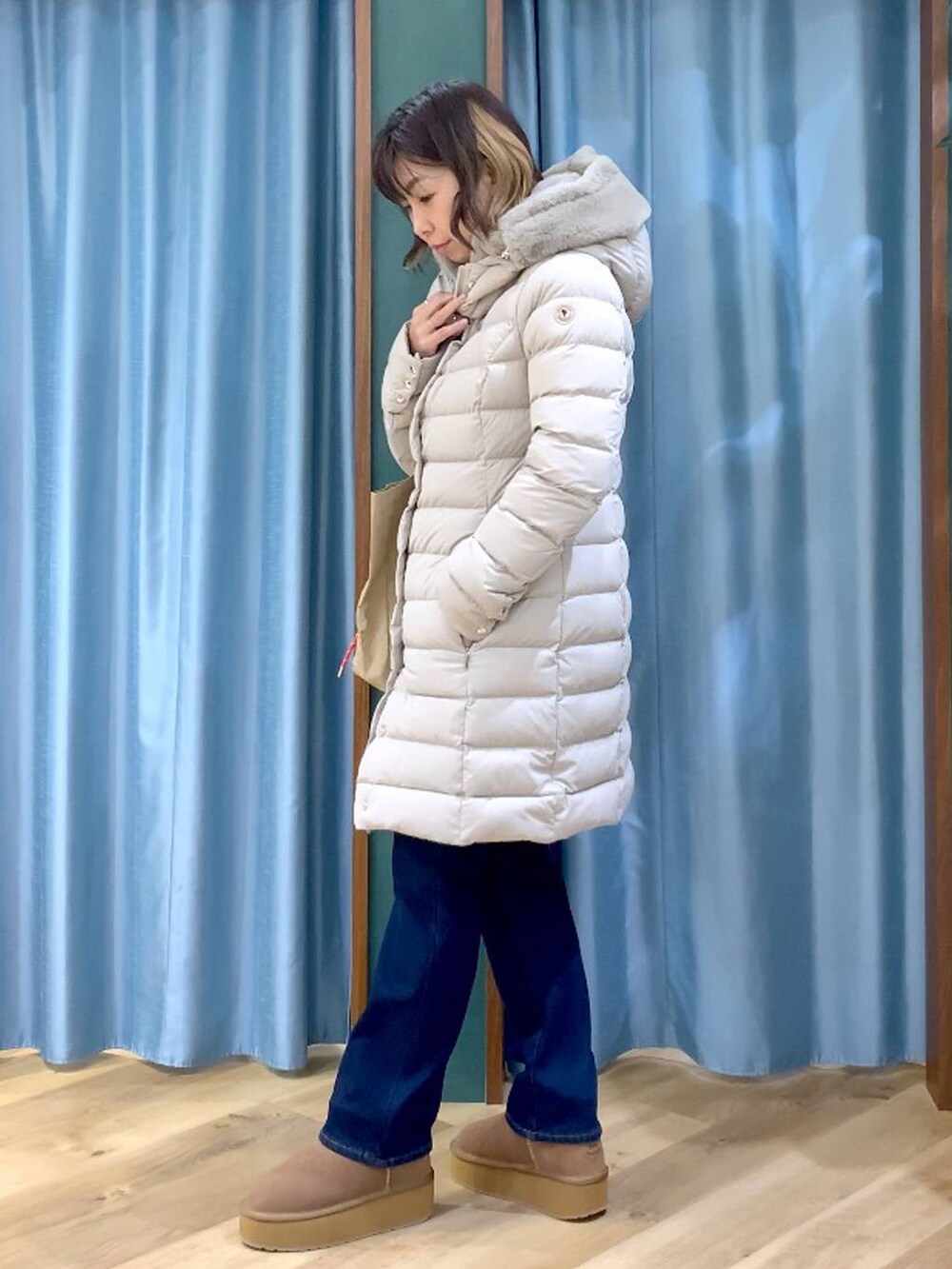 ベージュ系のトートバッグ、ブルー系のシャツ/ブラウス、ブルー系のデニムパンツを着用したレディースの秋コーディネートの4枚目の写真