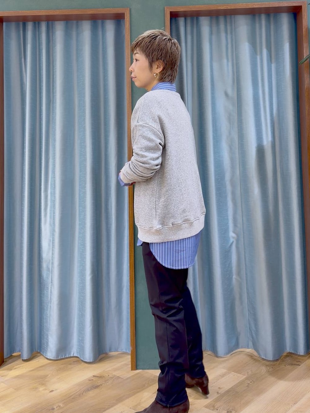 ブラック系のその他パンツ、ブラウン系のブーツ、ブルー系のシャツ/ブラウスを着用したレディースの秋コーディネートの4枚目の写真