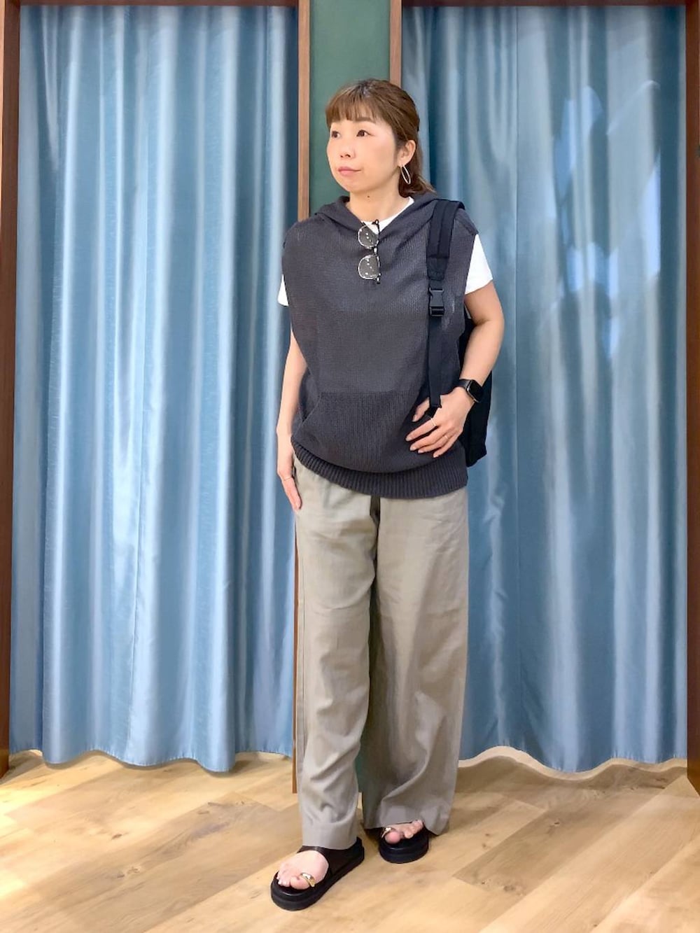 グレー系のニット/セーター、ブラウン系のその他パンツ、ブラック系のサンダルを着用したレディースの春コーディネートの3枚目の写真