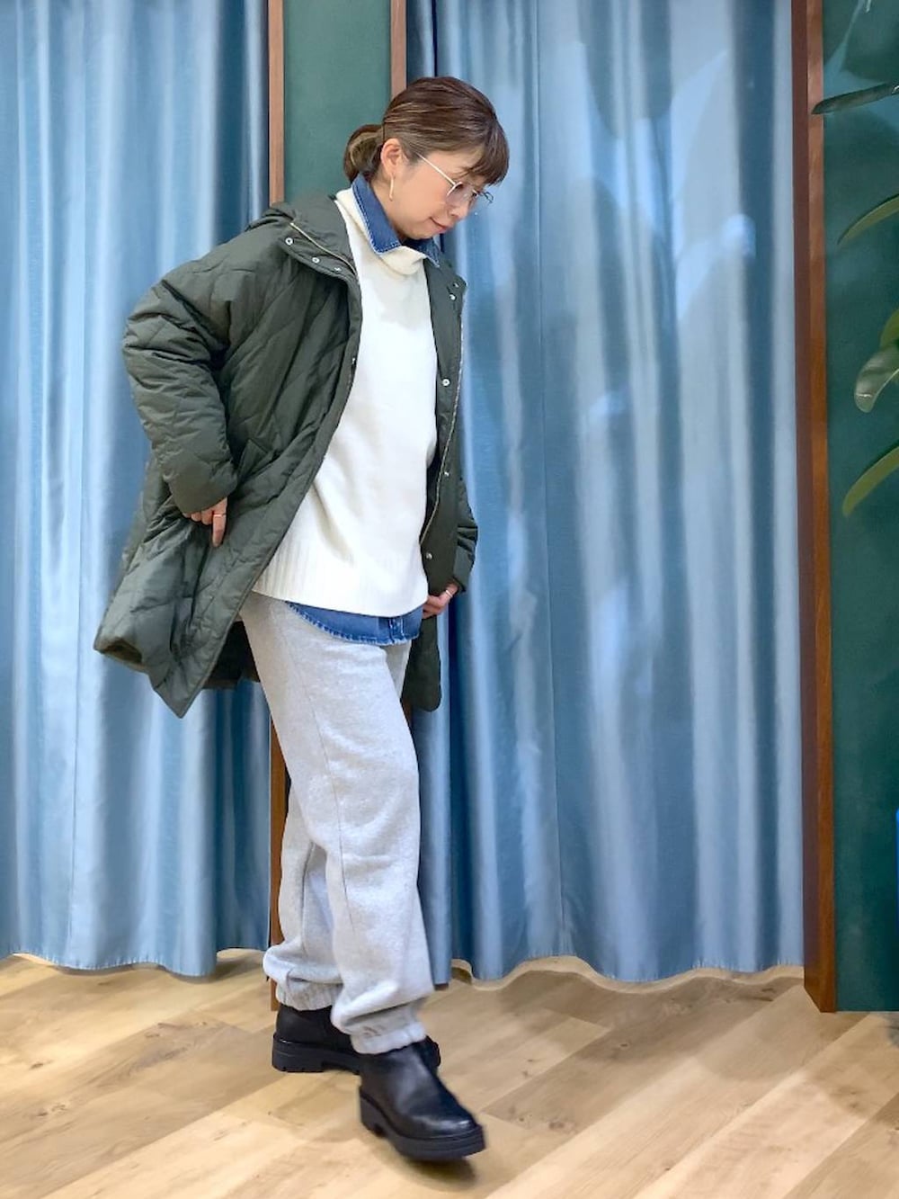 ブラック系のブーツ、ブルー系のシャツ/ブラウス、グリーン系のブルゾンを着用したレディースの秋コーディネートの3枚目の写真