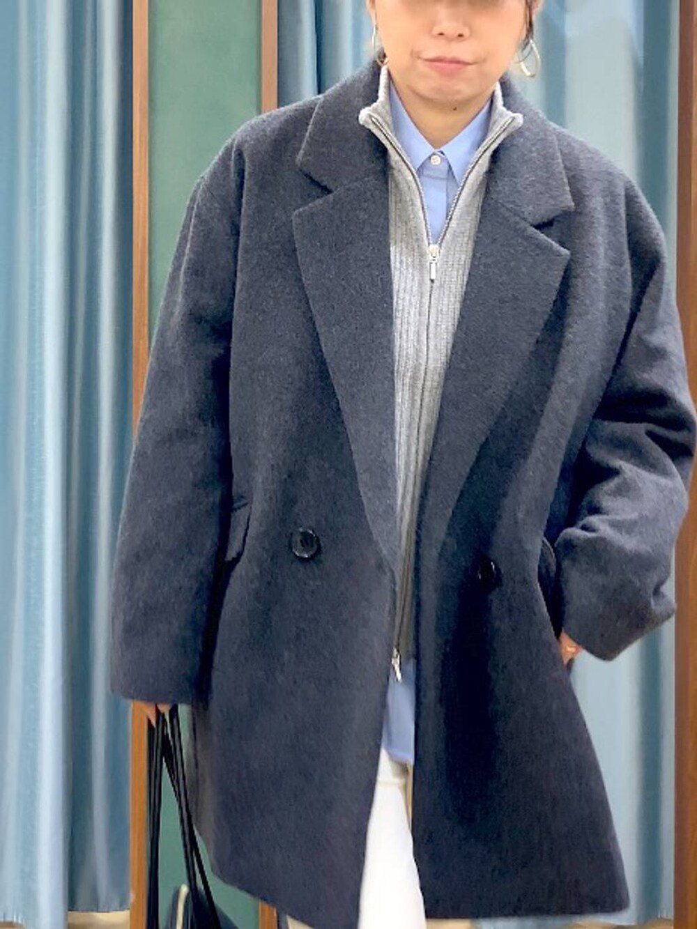 ブラック系のトートバッグ、ブルー系のシャツ/ブラウス、グレー系のベストを着用したレディースの秋コーディネートの6枚目の写真