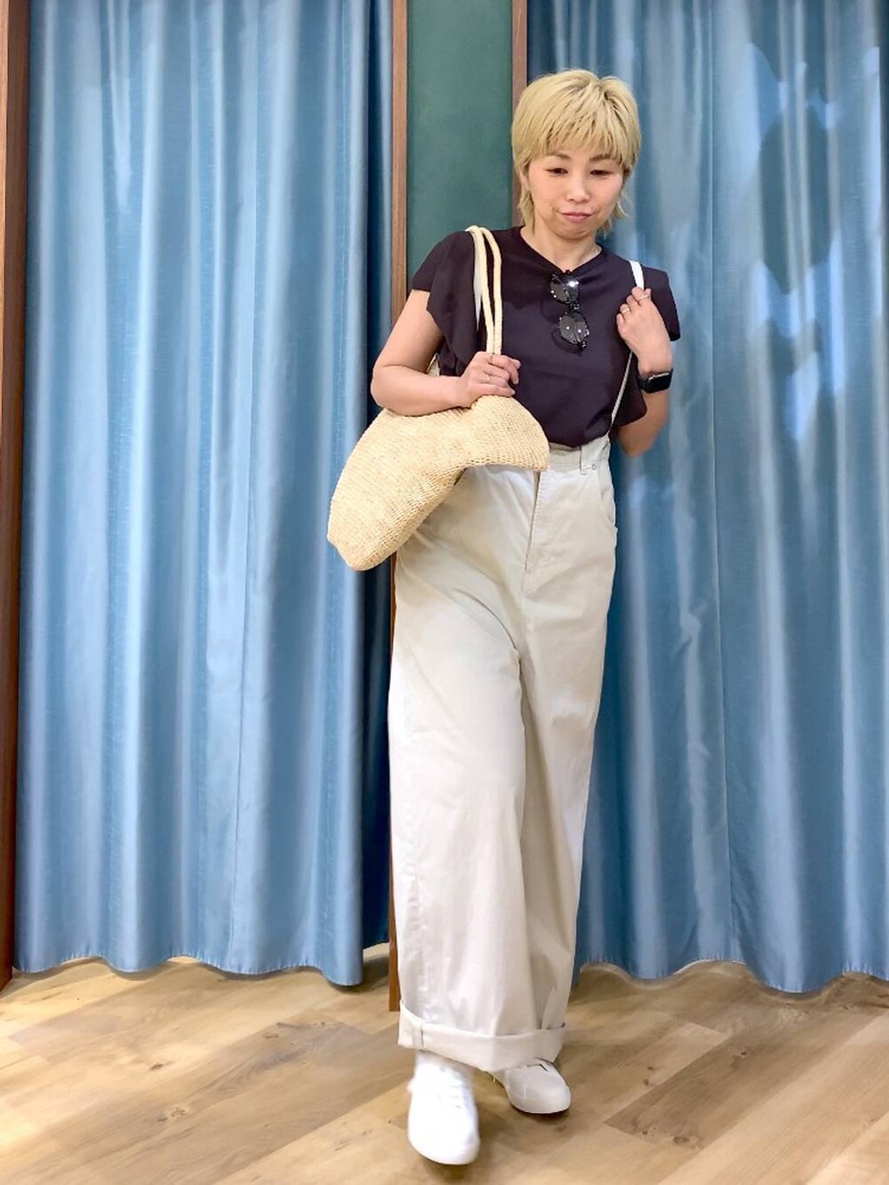 ベージュ系のその他パンツ、ブラウン系のニット/セーター、ベージュ系のかごバッグを着用したレディースの春コーディネートの2枚目の写真