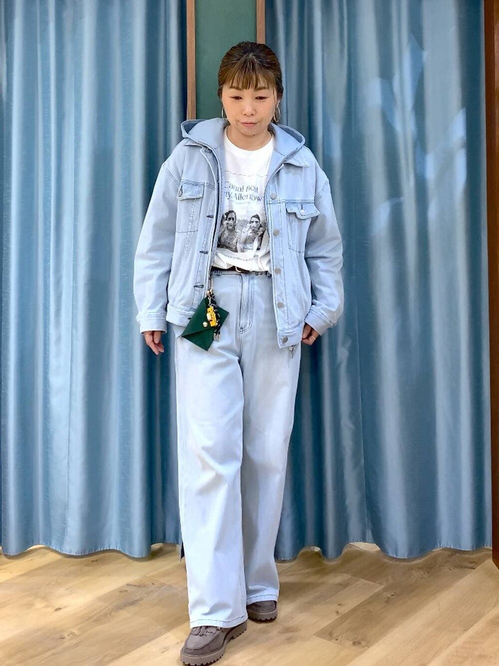 グレー系のローファー、ブルー系のデニムパンツ、ブルー系のデニムジャケットを着用したレディースの春コーディネートの2枚目の写真