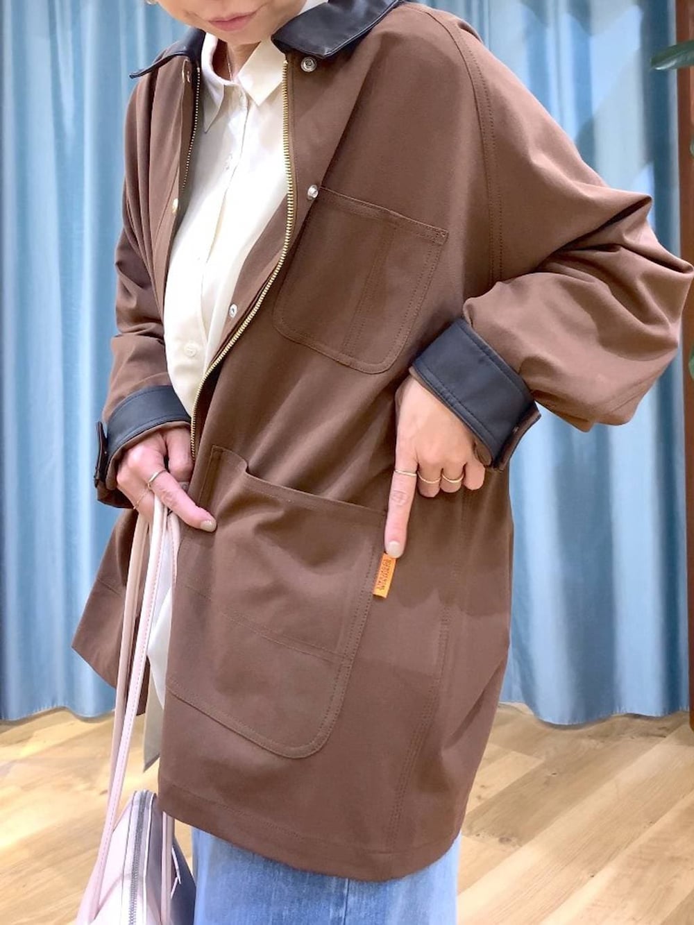 ブルー系のデニムパンツ、ブラウン系のカバーオール、ブラック系のローファーを着用したレディースの冬コーディネートの6枚目の写真