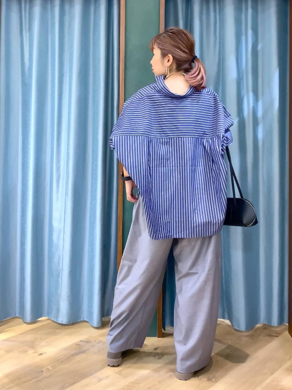 グレー系のローファー、グレー系のその他パンツ、ブルー系のシャツ/ブラウスを着用したレディースの春コーディネートの7枚目の写真