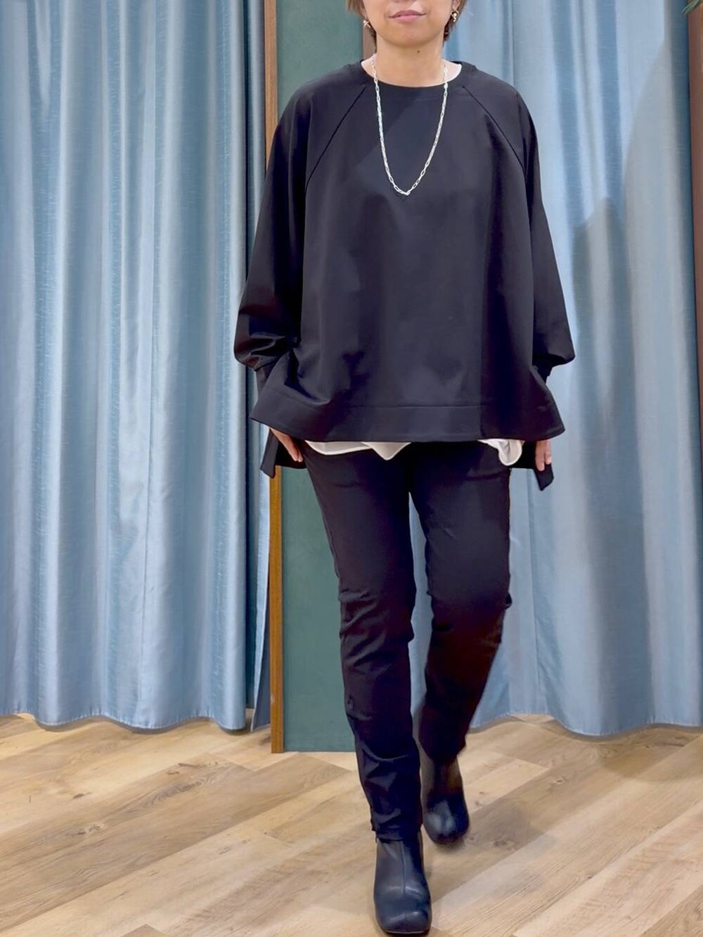 ブラック系のその他パンツ、ブラック系のブーツ、ホワイト系のTシャツ/カットソーを着用したレディースの秋コーディネートの10枚目の写真