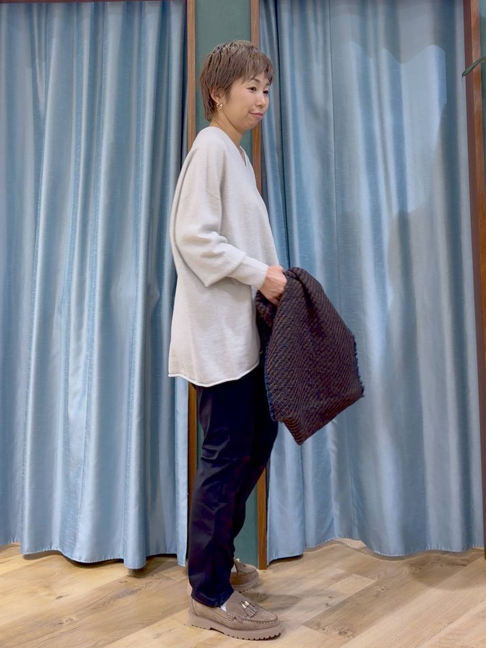 ブラック系のその他パンツ、ベージュ系のローファー、ベージュ系のニット/セーターを着用したレディースの秋コーディネートの6枚目の写真