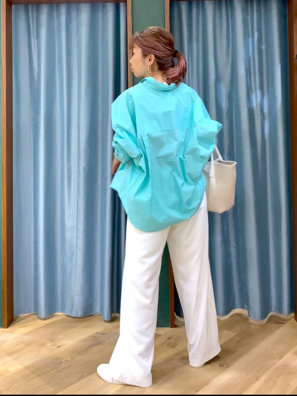 ホワイト系のスラックス、ブルー系のシャツ/ブラウス、ブラウン系のスニーカーを着用したレディースの春コーディネートの6枚目の写真