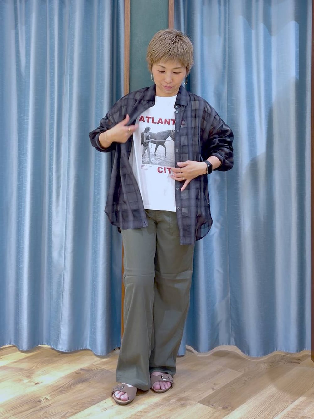 ホワイト系のTシャツ/カットソー、グリーン系のチノパンツ、ブラウン系のサンダルを着用したレディースの夏コーディネートの3枚目の写真