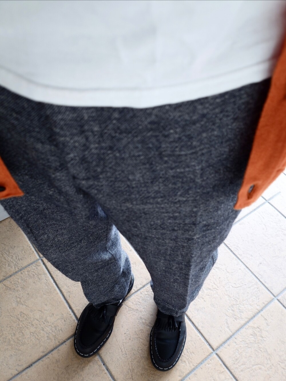 ブルー系のスラックス、ブラック系のローファー、ホワイト系のTシャツ/カットソーを着用したメンズの秋コーディネートの2枚目の写真