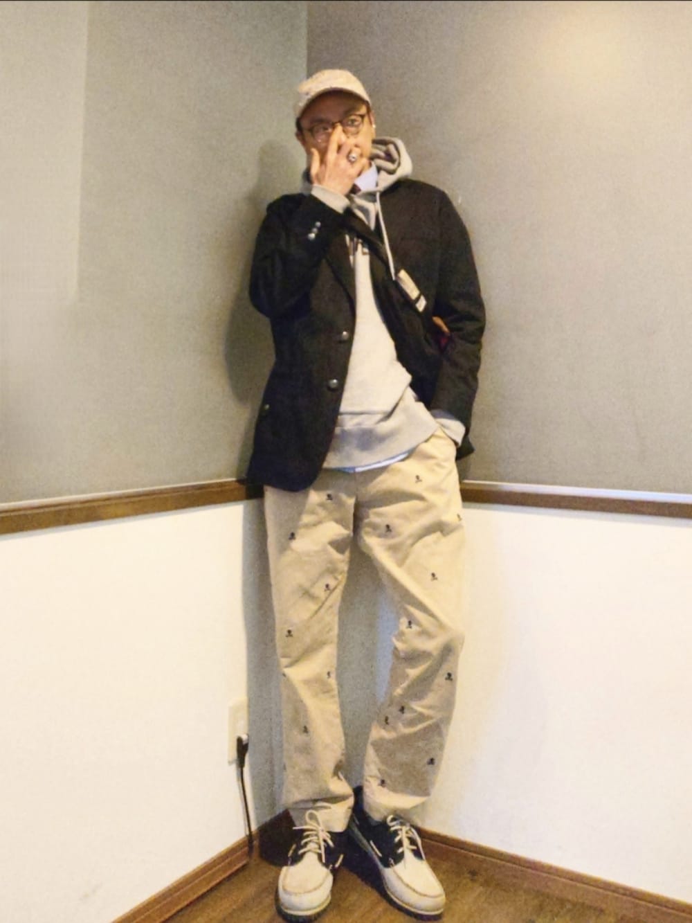 ピンク系のメッセンジャーバッグ、ブルー系のテーラードジャケット、グレー系のパーカーを着用したメンズの春コーディネートの2枚目の写真