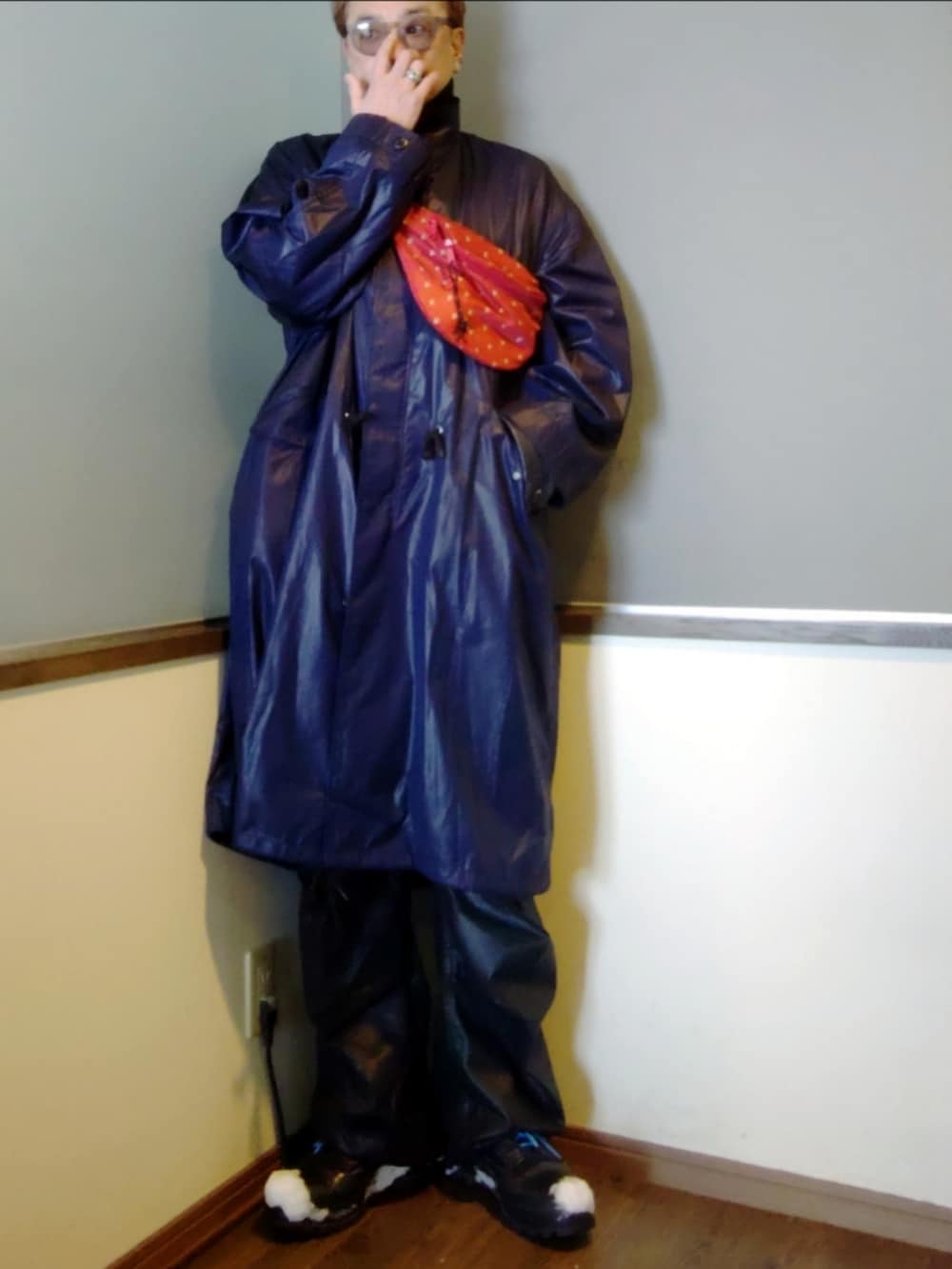 ブルー系のモッズコート、ブルー系のデニムジャケット、レッド系のショルダーバッグを着用したメンズの冬コーディネートの3枚目の写真