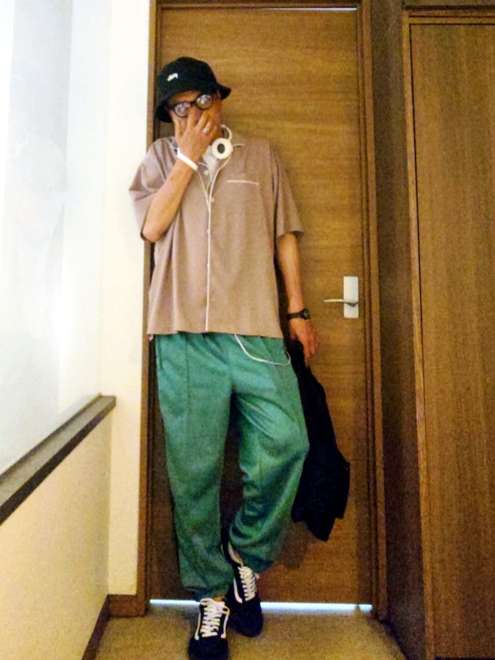 グリーン系のその他パンツ、ブラック系のスニーカー、ブラック系のバックパック/リュックを着用したメンズの夏コーディネートの2枚目の写真