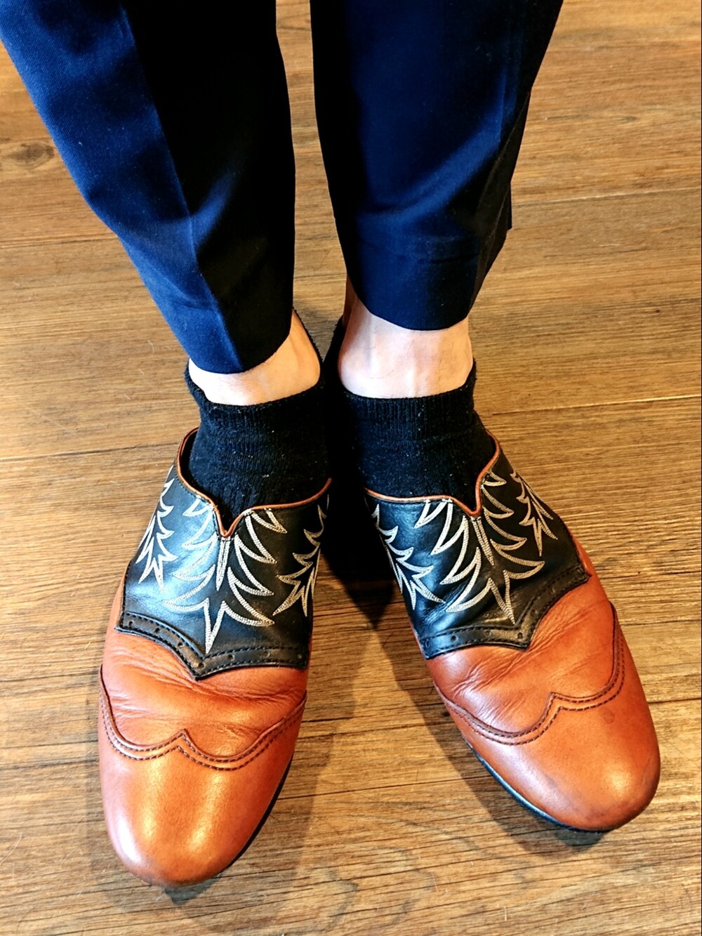 ベージュ系のステンカラーコート、レッド系のシャツ/ブラウス、ブルー系のスラックスを着用したメンズの春コーディネートの4枚目の写真