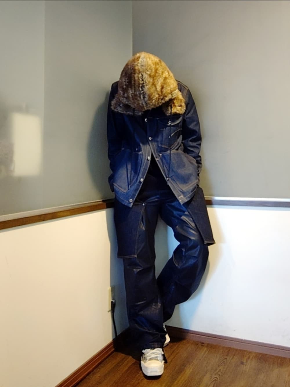 ブルー系のデニムジャケット、ブルー系のデニムパンツ、シルバー系のスニーカーを着用したメンズの秋コーディネートの2枚目の写真