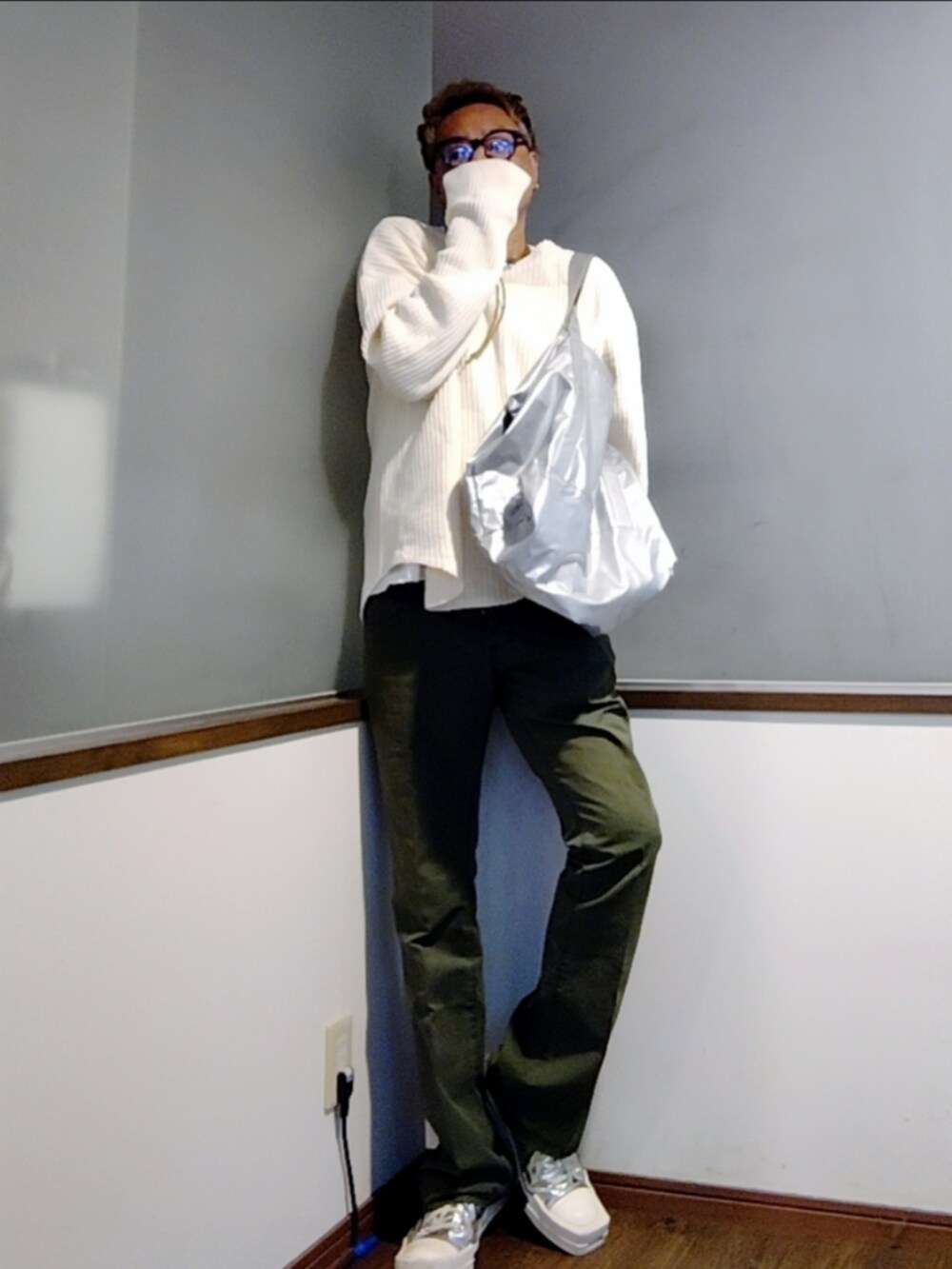 ベージュ系のTシャツ/カットソー、シルバー系のトートバッグ、グリーン系のスラックスを着用したメンズの秋コーディネートの2枚目の写真