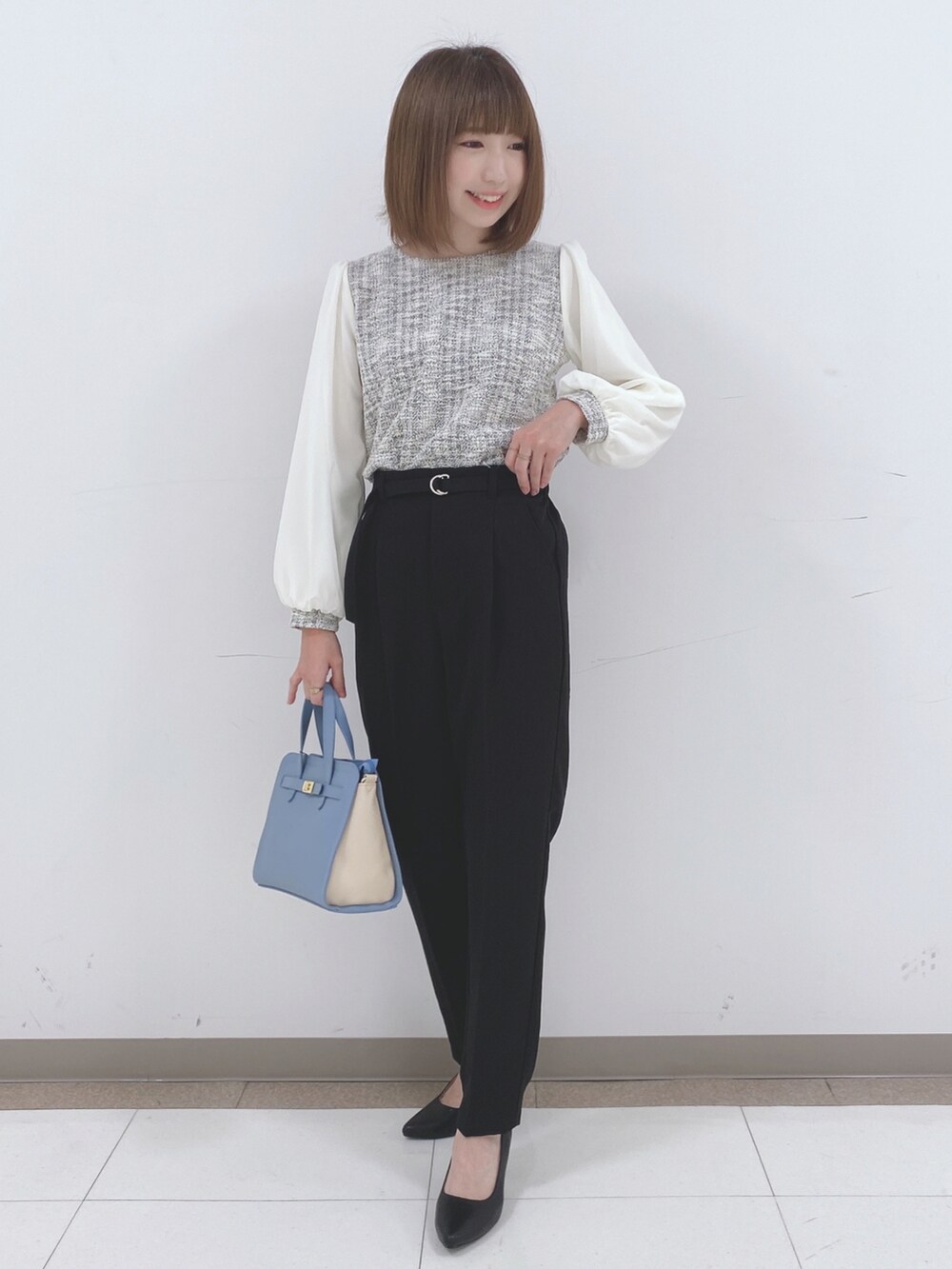ブラック系のその他パンツ、ブラック系のパンプス、ブルー系のトートバッグを着用したレディースの冬コーディネートの4枚目の写真
