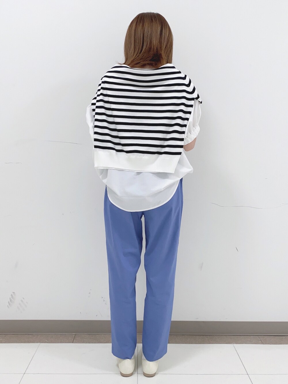 ホワイト系のTシャツ/カットソー、ブラック系のニット/セーター、ブルー系のその他パンツを着用したレディースの春コーディネートの3枚目の写真