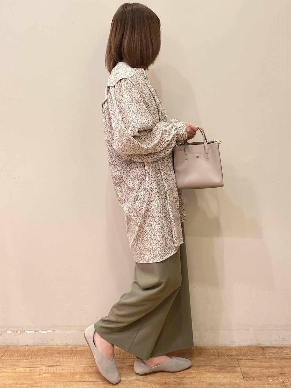 グリーン系のサロペット/オーバーオール、ベージュ系のチュニック、ホワイト系のTシャツ/カットソーを着用したレディースの春コーディネートの2枚目の写真