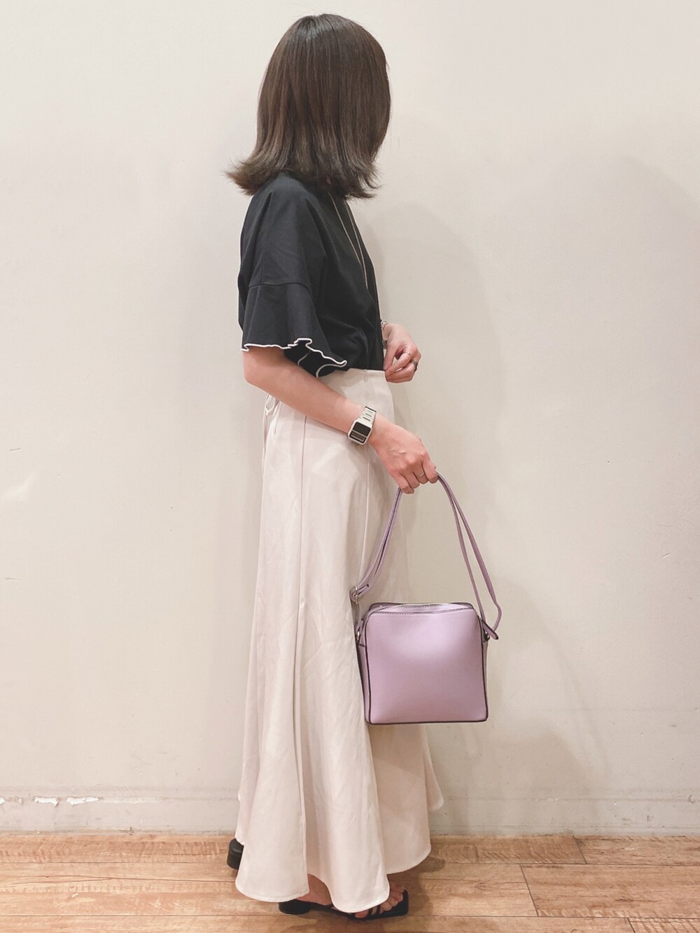 ブラック系のTシャツ/カットソー、ブラック系のサンダル、パープル系のショルダーバッグを着用したレディースの春コーディネートの2枚目の写真