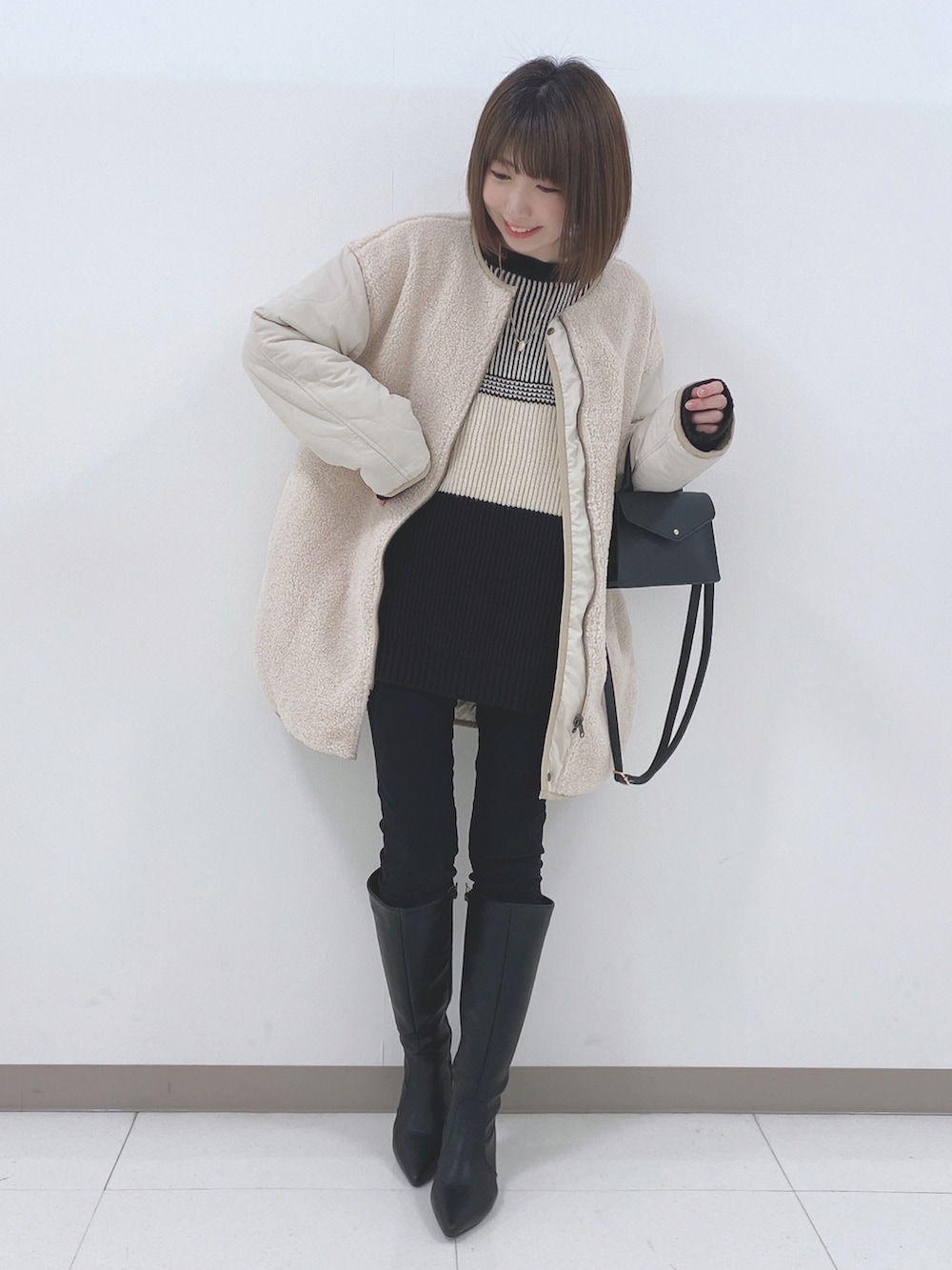 ベージュ系のノーカラージャケット、ブラック系のニット/セーター、ブラック系のその他パンツを着用したレディースの冬コーディネートの4枚目の写真