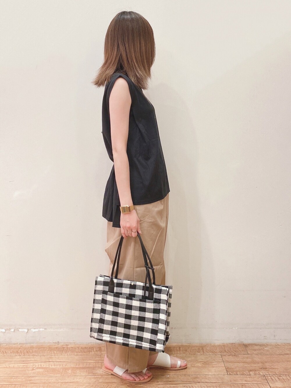 ブラック系のTシャツ/カットソー、ベージュ系のその他パンツ、ホワイト系のサンダルを着用したレディースの夏コーディネートの2枚目の写真