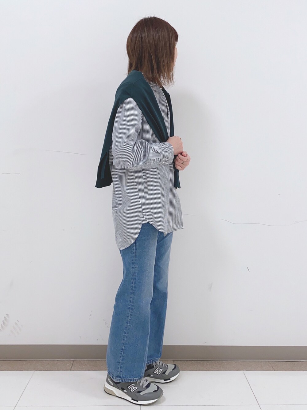 ブルー系のシャツ/ブラウス、ブルー系のデニムパンツ、グリーン系のカーディガン/ボレロを着用したレディースの春コーディネートの2枚目の写真