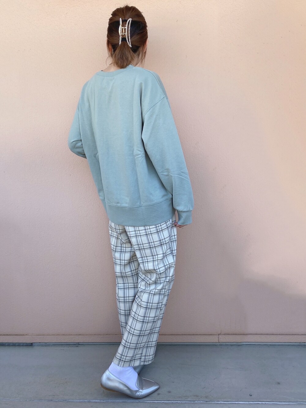 グリーン系のスウェット、シルバー系のその他シューズ、グレー系のその他パンツを着用したレディースの冬コーディネートの2枚目の写真