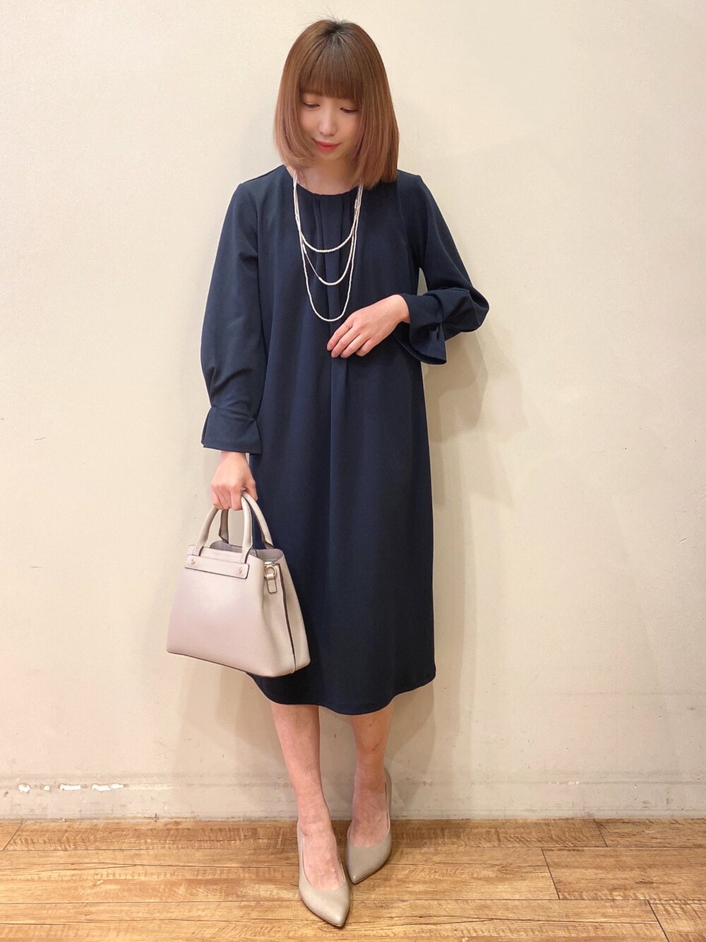 ブルー系のワンピース、グレー系のショルダーバッグ、グレー系のパンプスを着用したレディースの冬コーディネートの2枚目の写真