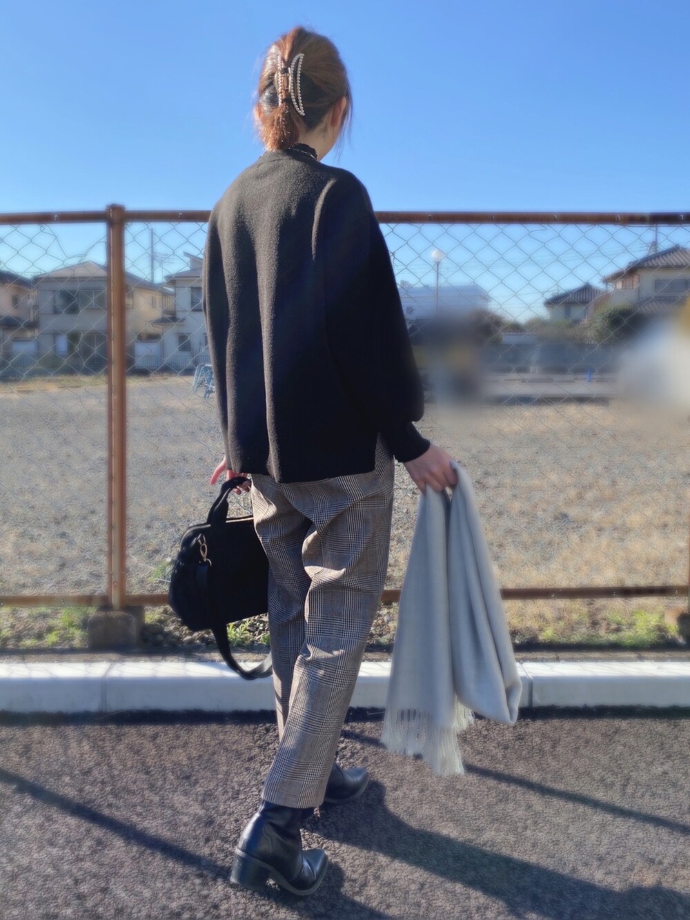 ブラック系のニット/セーター、ブラック系のトートバッグ、ブラウン系のその他パンツを着用したレディースの冬コーディネートの3枚目の写真