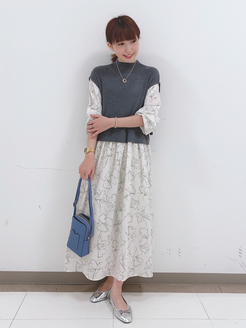 グレー系のワンピース、ブルー系のショルダーバッグを着用したレディースの春コーディネートの4枚目の写真