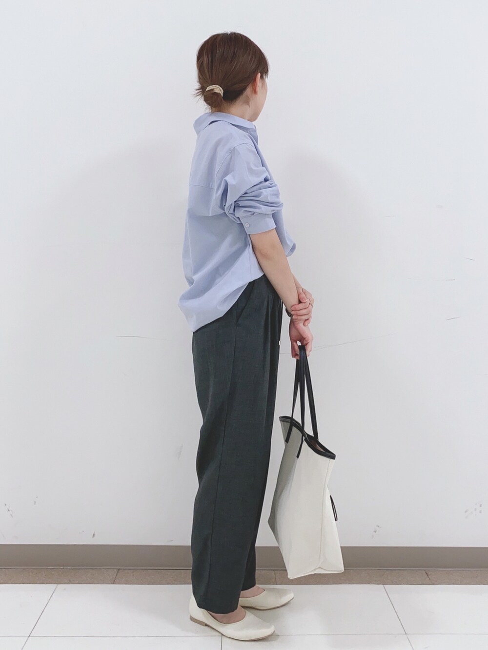 ブルー系のシャツ/ブラウス、グレー系のその他パンツ、ホワイト系のパンプスを着用したレディースの春コーディネートの2枚目の写真