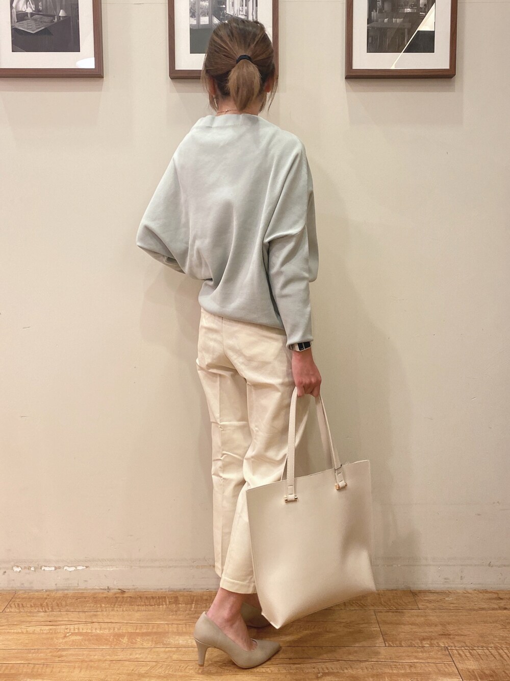 グリーン系のニット/セーター、ホワイト系のその他パンツ、ベージュ系のパンプスを着用したレディースの冬コーディネートの2枚目の写真