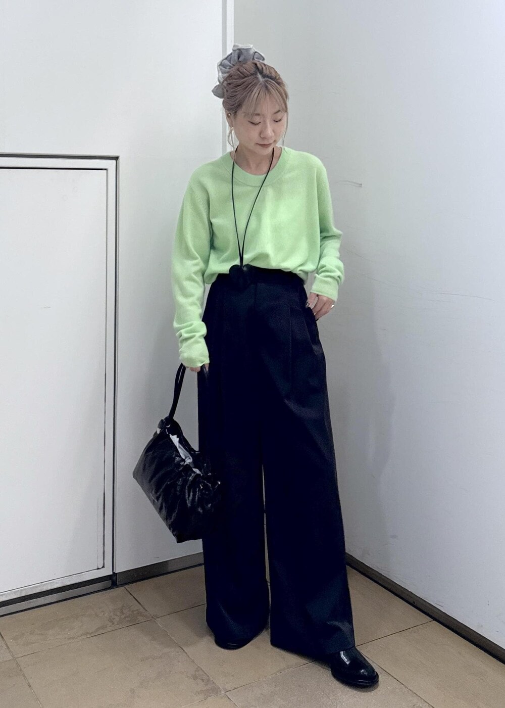 ブラック系のその他パンツ、ブラック系のサンダル、グリーン系のニット/セーターを着用したレディースの秋コーディネートの2枚目の写真