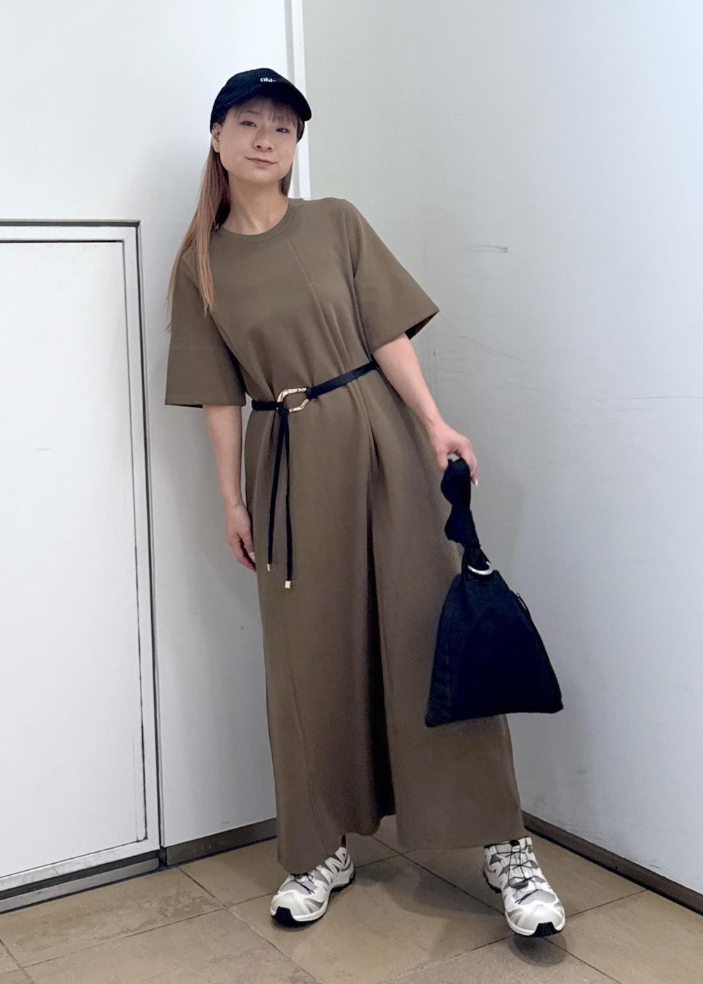 ブラウン系のワンピース、ブラック系のハンドバッグを着用したレディースの夏コーディネートの3枚目の写真