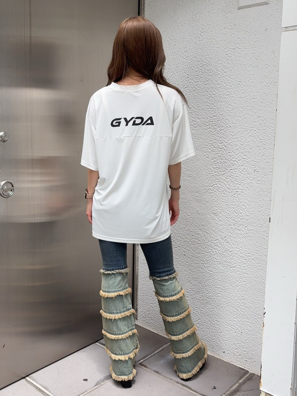 ホワイト系のTシャツ/カットソー、ブルー系のデニムパンツ、ブラック系のサンダルを着用したレディースの夏コーディネートの3枚目の写真